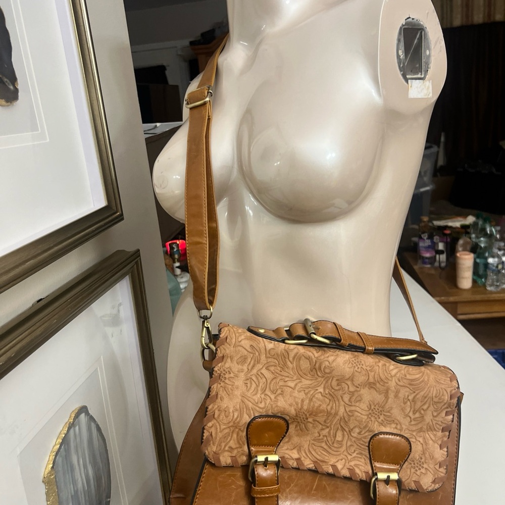 Tan faux leather satchel or crossbody bag featuring a Embossed Flab Buckles